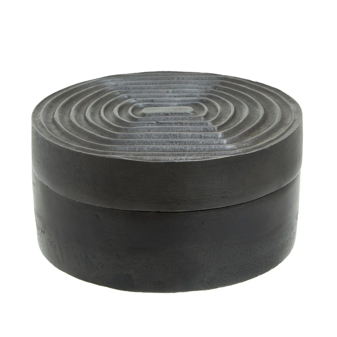 Round black stone box with concentric circular pattern on lid