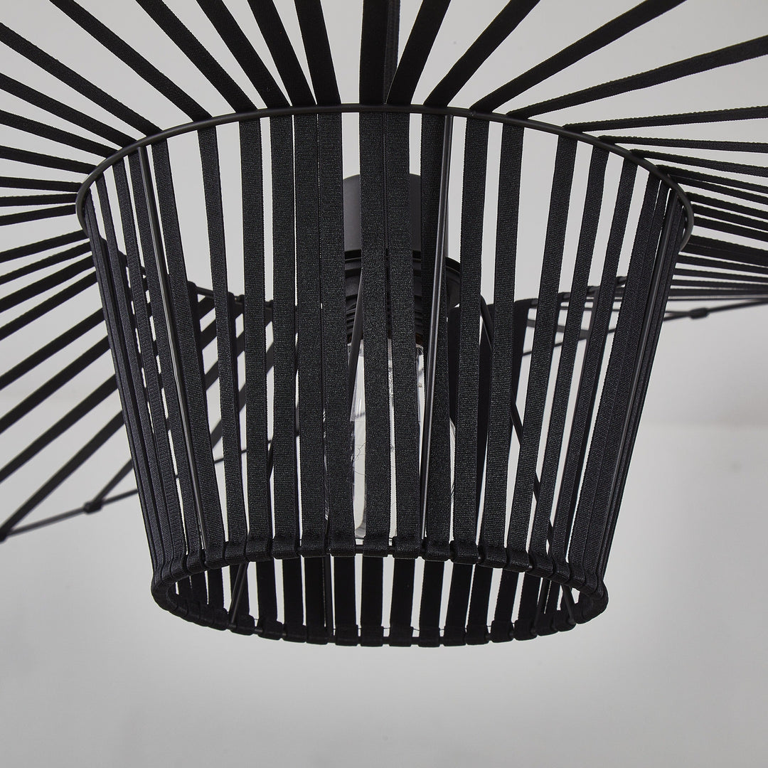 Black metal basket with a starburst pattern on a white background