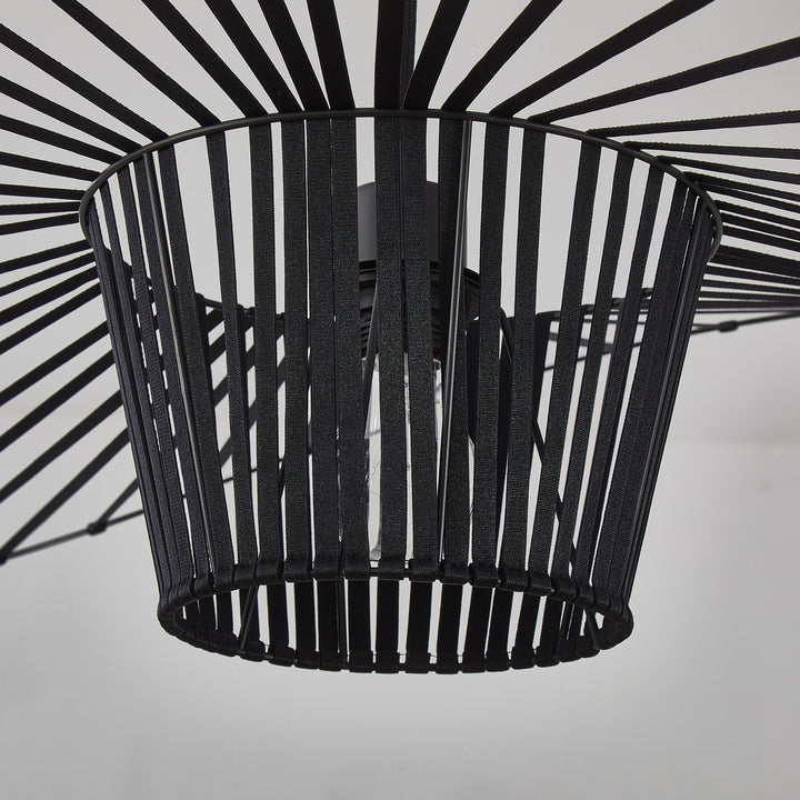 Black metal basket with a starburst pattern on a white background