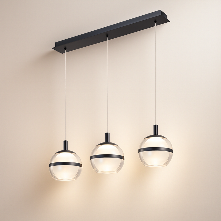 Black trim 3 light glass pendant bar with light background.