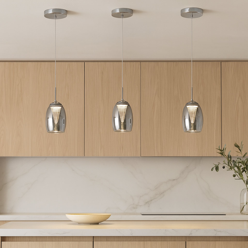 Three Adelaide smoked glass pendant lights attached to the ceiling above a luxury marble kitchen island with wood cabinets