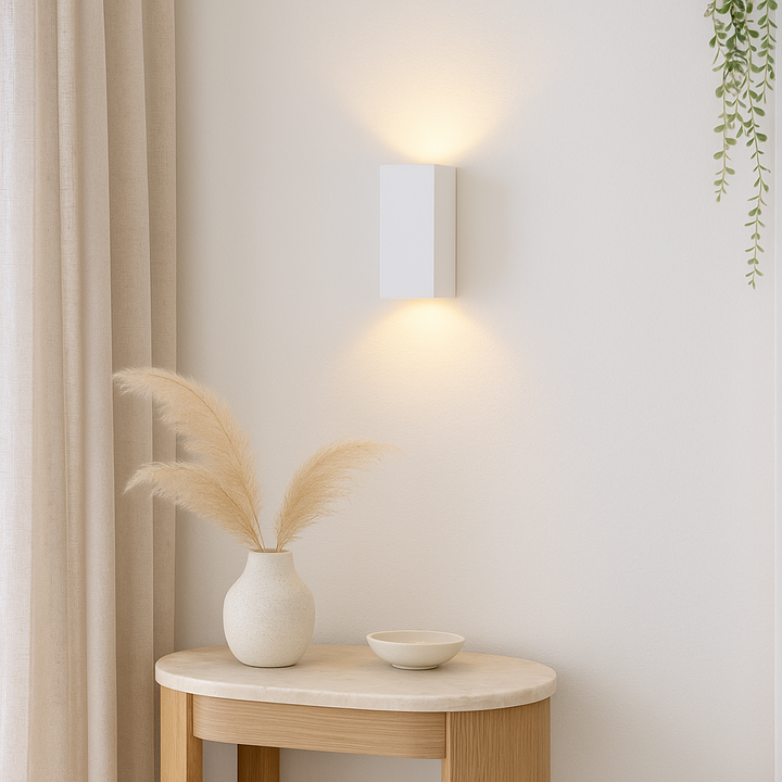 Adelong modern white rectangular wall light styled in a light and airy interior with console table, pampas vase, and neutral décor
