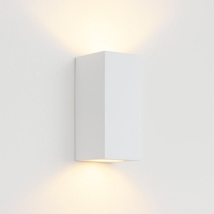 Adelong modern white rectangular wall light on white background with warm up and down glow.