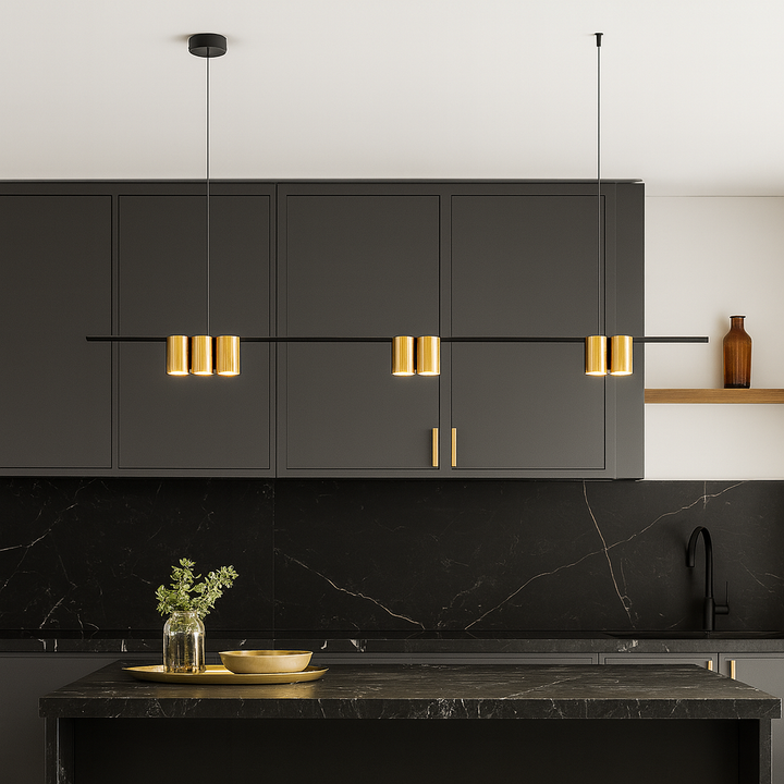 Modern black and gold bar pendant light hanging over a luxury kitchen island with black cabinetry and marble finishes.