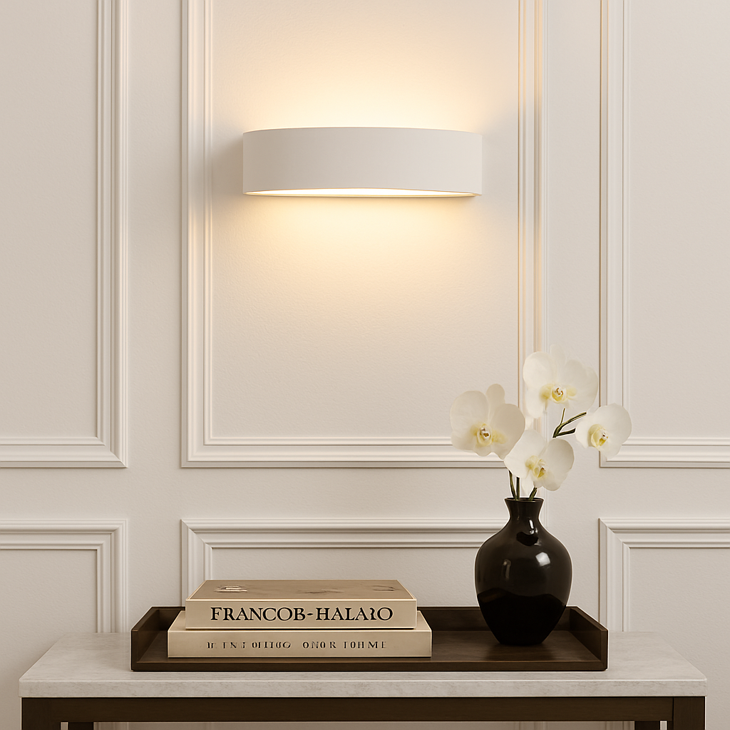 Decorative setup with a vase of flowers on a table against a wall with a framed mirror.