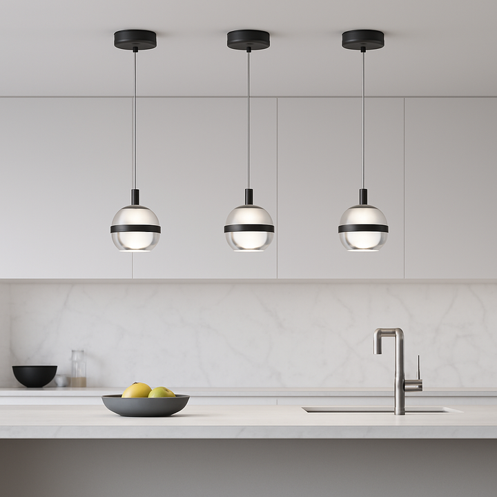 Modern black 3 light glass globe pendant bar above a white marble kitchen island with crisp minimal cabinetry