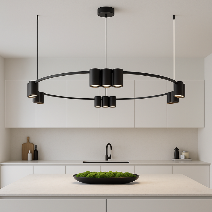 Modern black circular pendant light with three suspension cables above a minimalist white handleless kitchen island with moss bowl