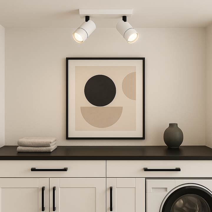 White 2-light ceiling spotlight bar in modern utility room with black countertop and white cabinets