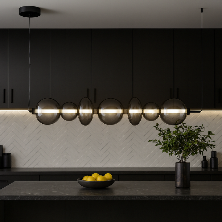 Europa Lighting black glass pendant bar light hanging in a modern kitchen with black accents and wide marble island