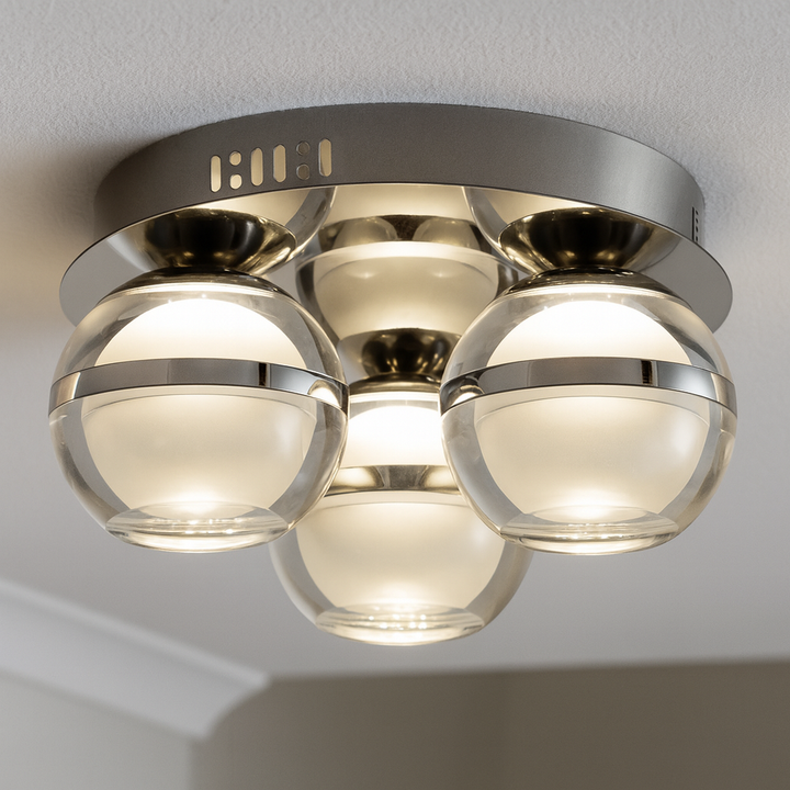 Modern silver flush ceiling light with three glass globes mounted on a circular metal base, styled in a contemporary interior.