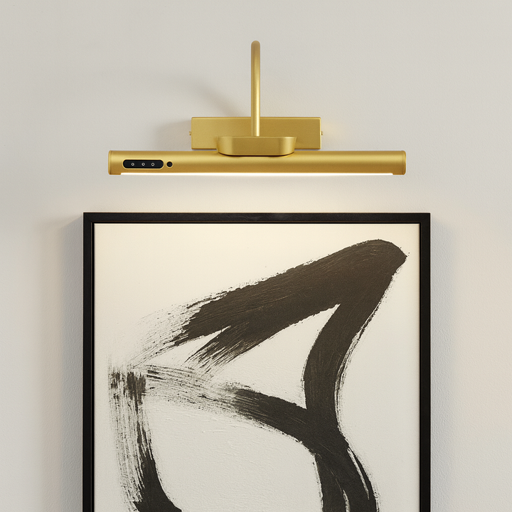Gold picture light 35cm wide mounted above a modern black and white artwork on a white wall