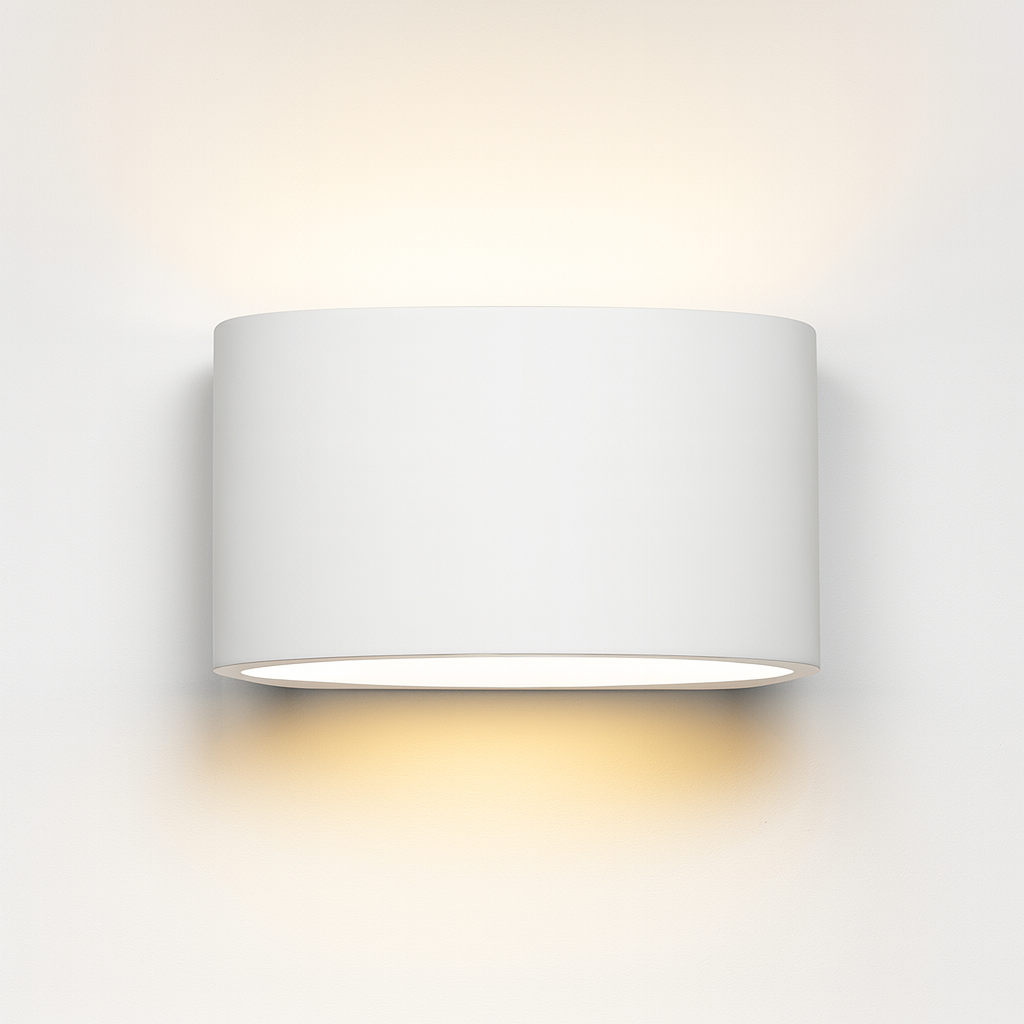 Midland ceramic wall light with smooth cylindrical design, paintable finish, and warm up-and-down glow on a white background