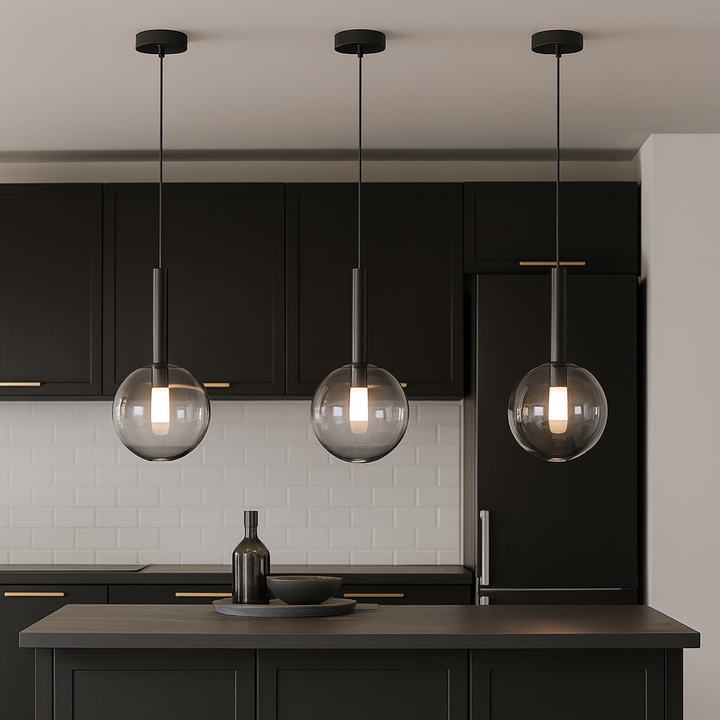 Modern kitchen with black accents featuring three 20cm glass globe pendant lights hanging proportionally over a small island.