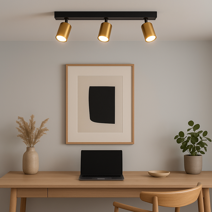 Modern home office with wooden desk, minimalist artwork, and the Benalla black and gold 3 light bar flush ceiling fitting providing warm illumination