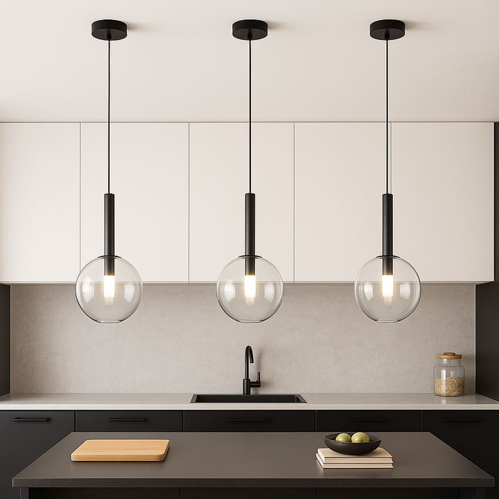 Modern kitchen with black accents featuring three 20cm glass globe pendant lights hanging over a small island, with white top cupboards and a light worktop