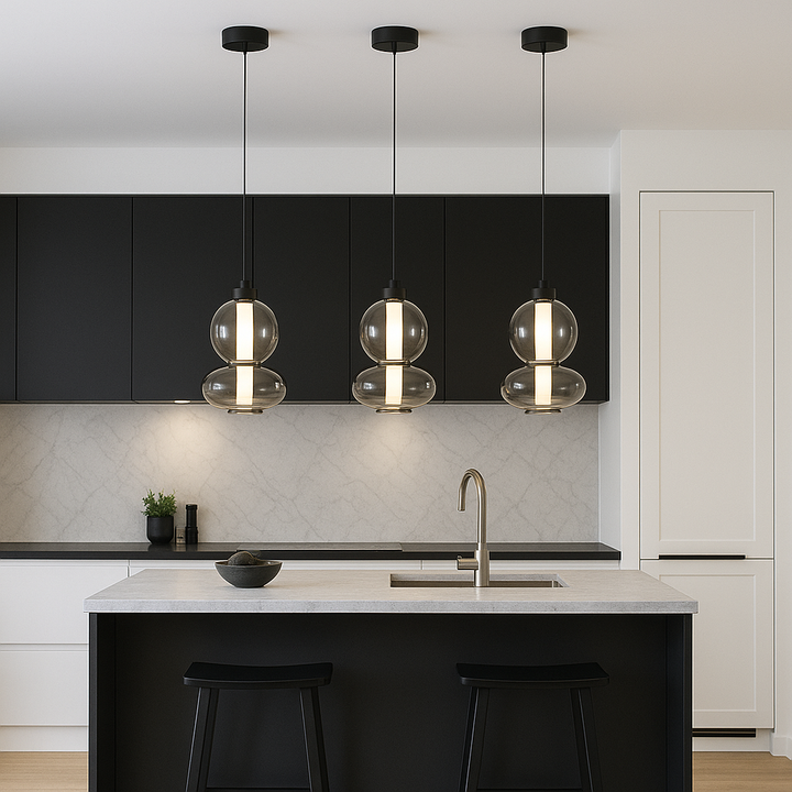 Modern kitchen with black accents featuring three 20cm glass pendant lights hanging proportionally over a small island.