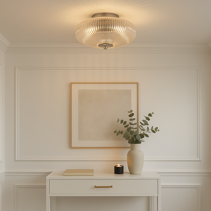 Nantwich ribbed glass ceiling light in a luxury hallway with white panelled walls, console table, artwork, vase, and candle.