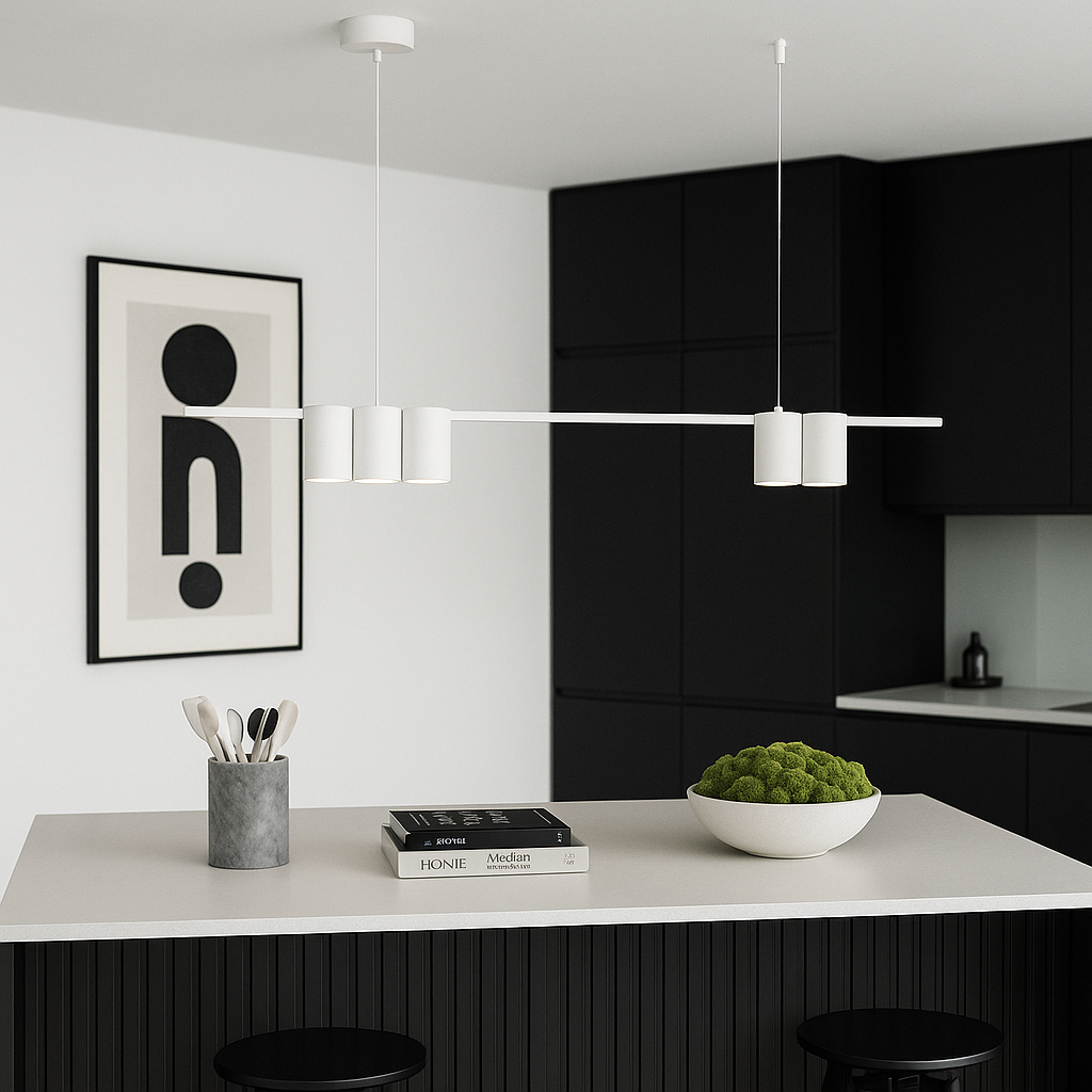 Nordic style black kitchen with white bar pendant light above island, simple artwork on wall, and decorative bowl filled with green moss.