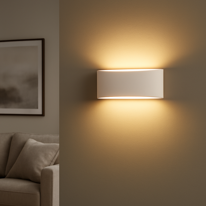 Nova Lighting Batlow medium wall light in paintable ceramic plaster casting warm glow on wall in a modern neutral living room