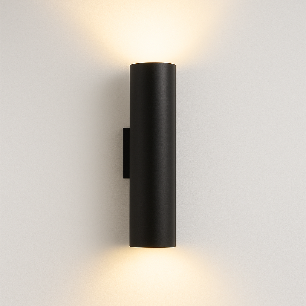 Pictou black cylindrical wall light with warm glow on white background