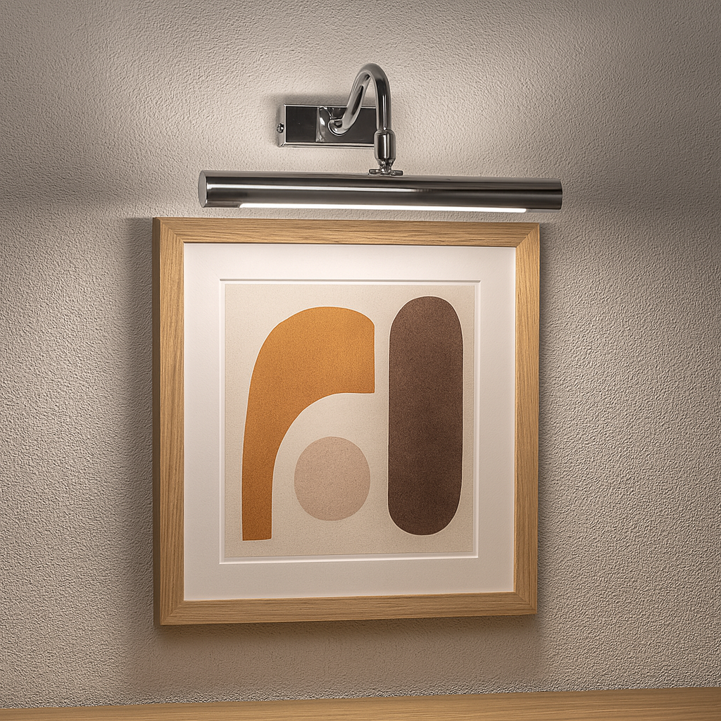 Polished silver picture wall light 28cm wide illuminating framed modern abstract artwork on a grey wall