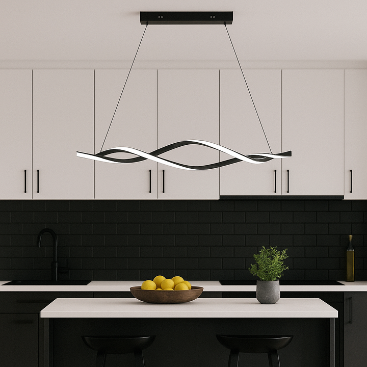 Pompei LED pendant bar light hanging above a modern kitchen island with white cabinets and black accents