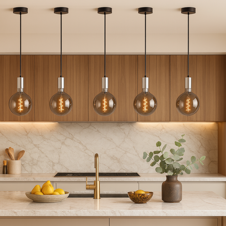 Tiber polished silver smoked pendants above marble kitchen island