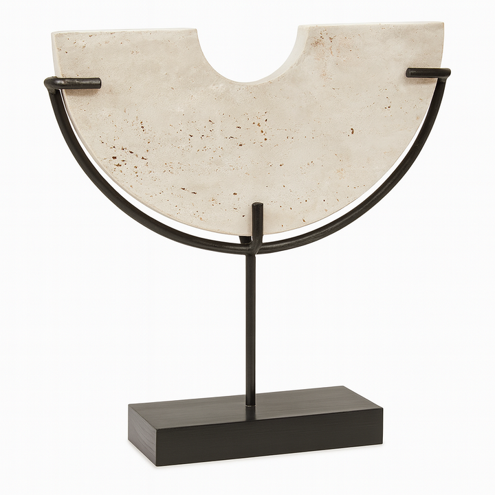 Luxury product image of white travertine semi-circular sculpture on black metal stand with soft shading against a clean white background.