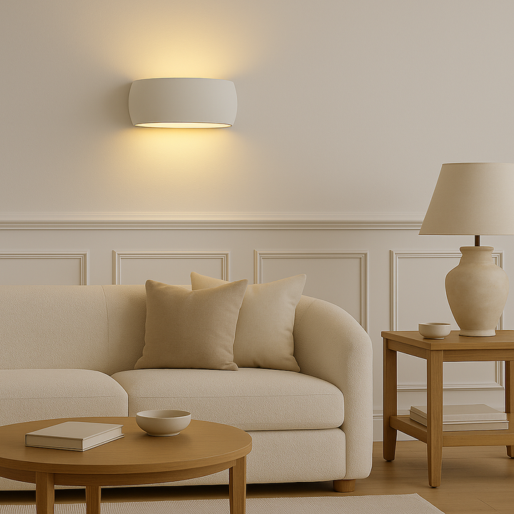 Windsor Large ceramic wall light glowing softly above a neutral sofa in a luxury living room with white panelled walls, natural wood furniture, and Scandi-inspired styling
