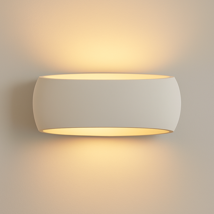 Windsor Large ceramic wall light with smooth oval design, casting warm up-and-down glow on a white background