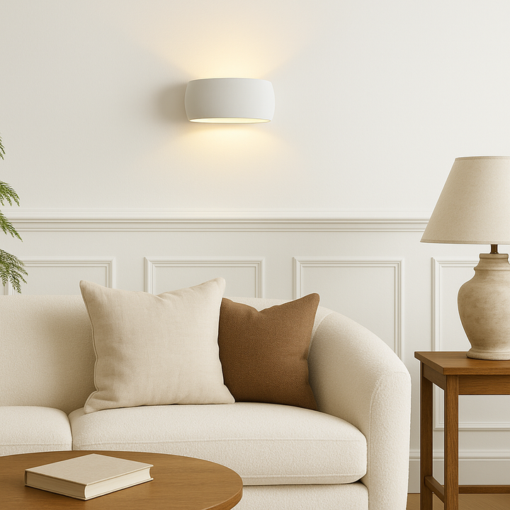 Windsor Small ceramic wall light in proportion above a cream sofa with white walls and luxury living room styling