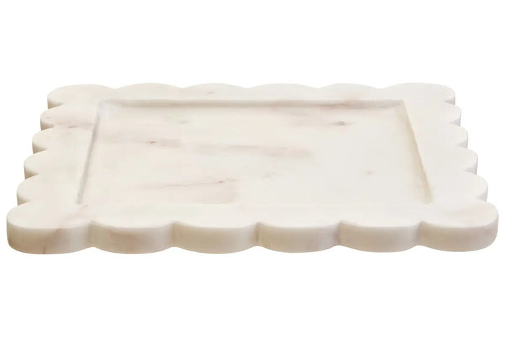 Rectangular white ceramic plate with scalloped edge on a white background
