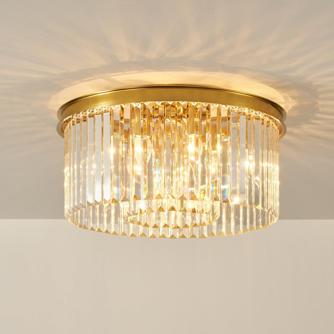 A gold flush ceiling light fixture with clear crystal shards arranged in rows, designed to be a statement piece for low ceilings.