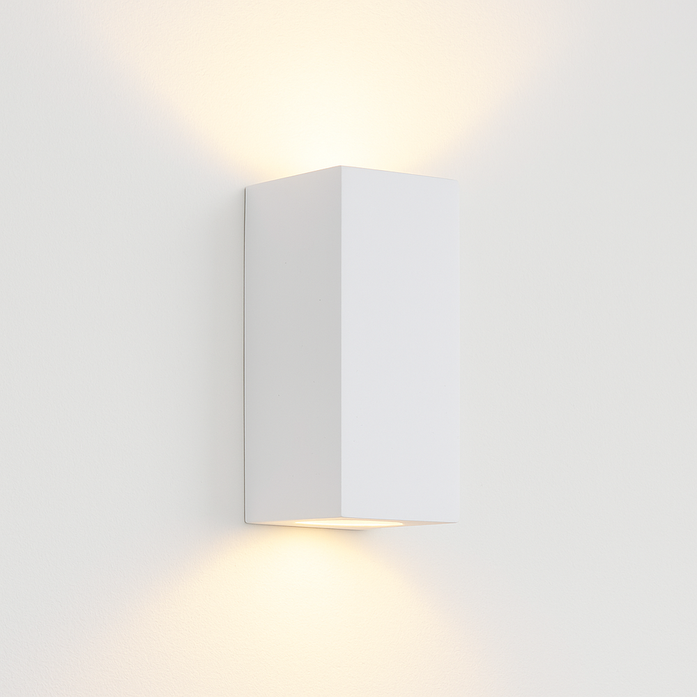 Adelong modern white rectangular wall light on white background with warm up and down glow.
