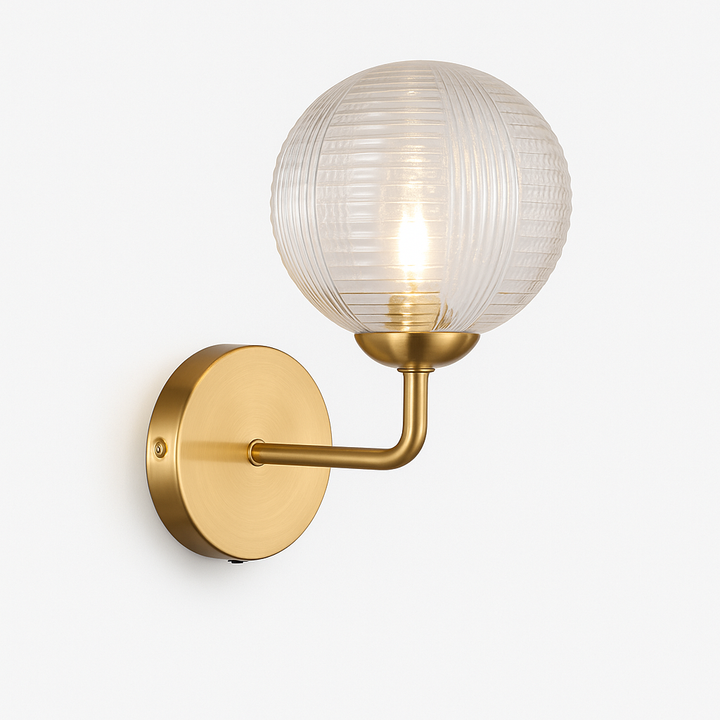 Brass wall light with ribbed glass globe