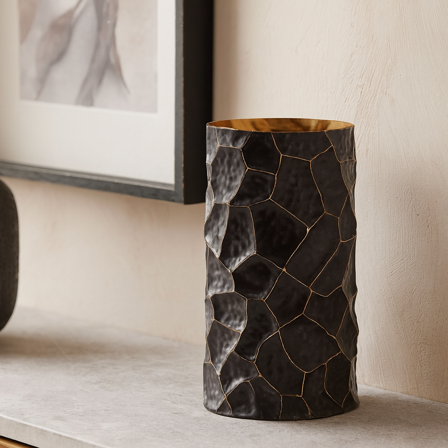 Luxury black and gold textured metal vase styled on a sideboard in a modern interior