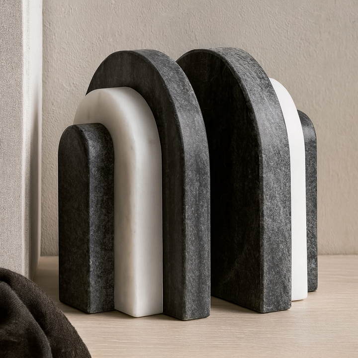 Pair of black and white marble arch bookends styled on a wooden surface in a modern luxury interior