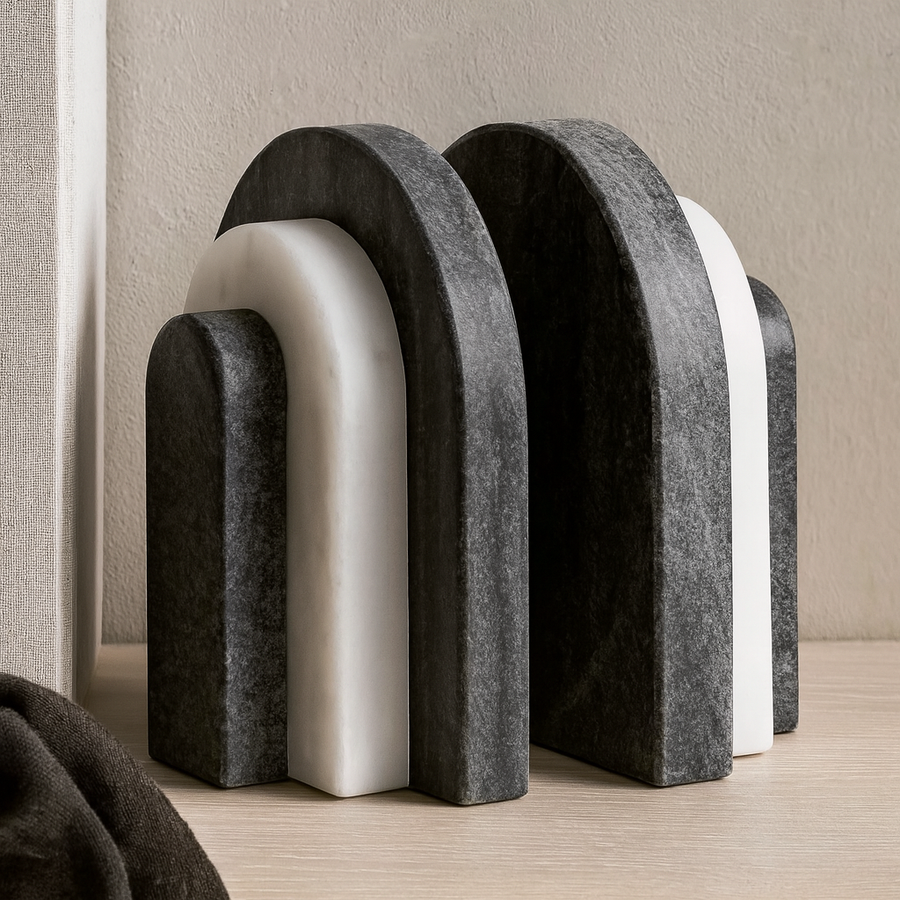 Pair of black and white marble arch bookends styled on a wooden surface in a modern luxury interior