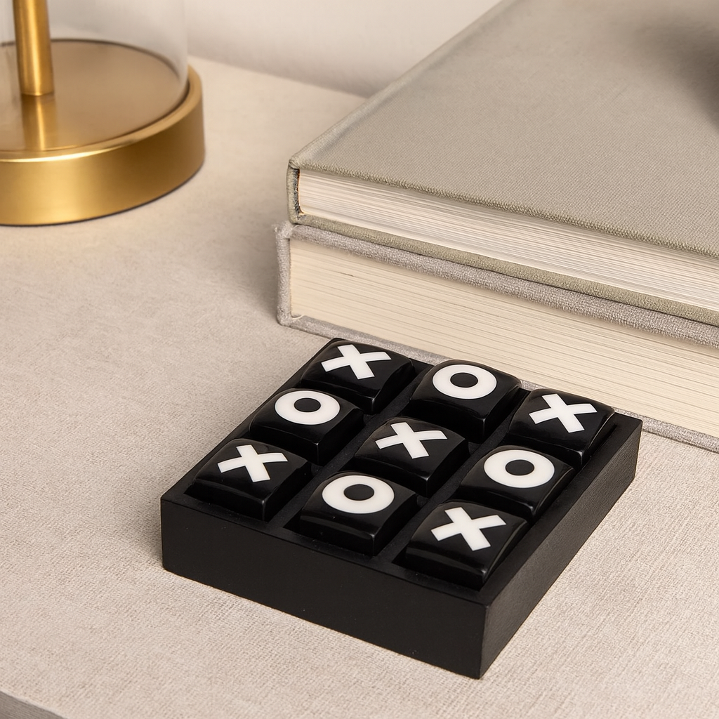 Luxury black and white tic tac toe game set styled as a small decorative accessory on a modern table