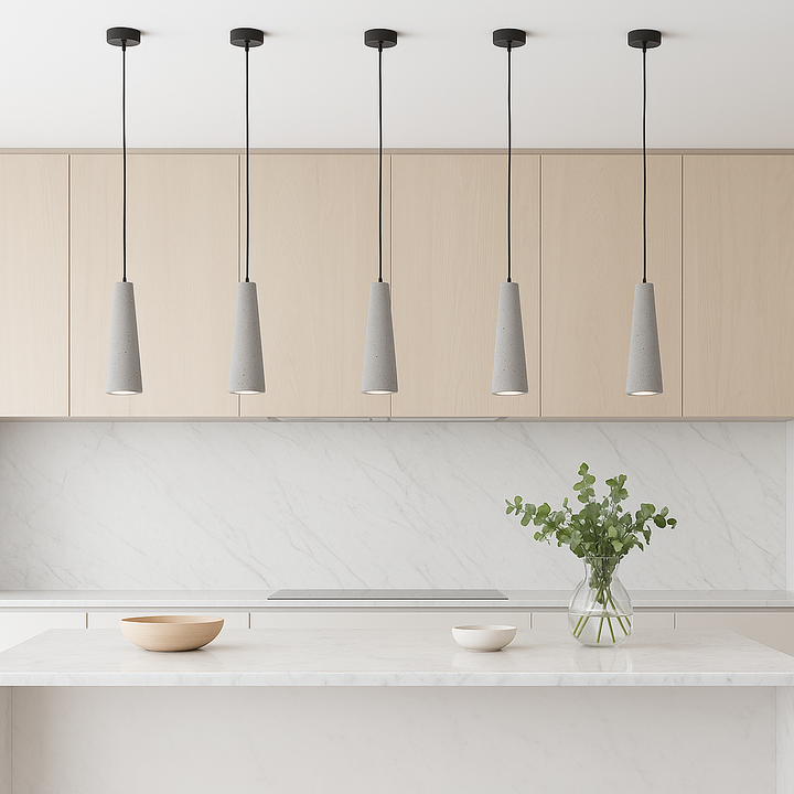 Five Bonavista concrete pendant lights above a white marble island in a Scandinavian modern kitchen with light cabinetry