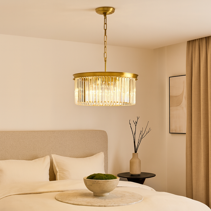 Luxury bedroom with Carolina gold crystal chandelier above a modern upholstered bed, neutral bedding, and elegant decor