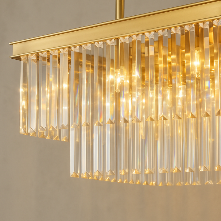 Close-up of Carolina gold rectangular crystal pendant chandelier with shimmering glass prisms and warm golden glow