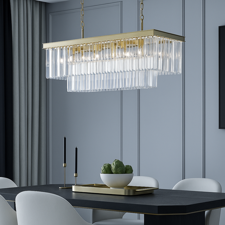Luxury gold rectangular crystal pendant light above a modern black dining table with cream chairs and gold accents