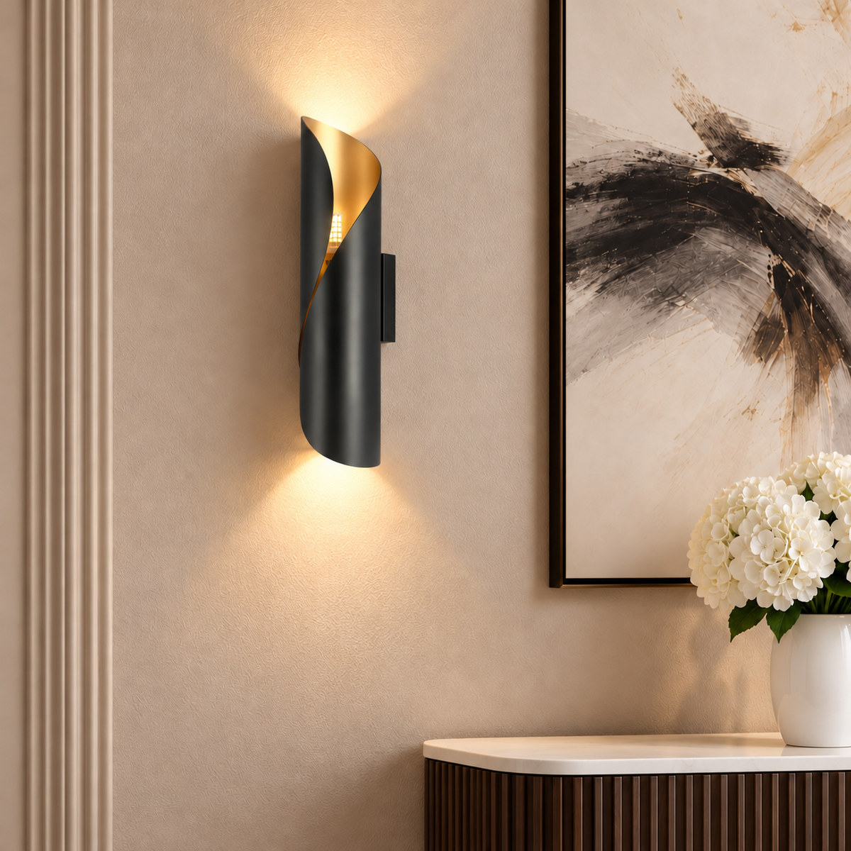 Illuminated Cordoba black and gold wall light beside abstract artwork above a walnut console in an elegant hallway.