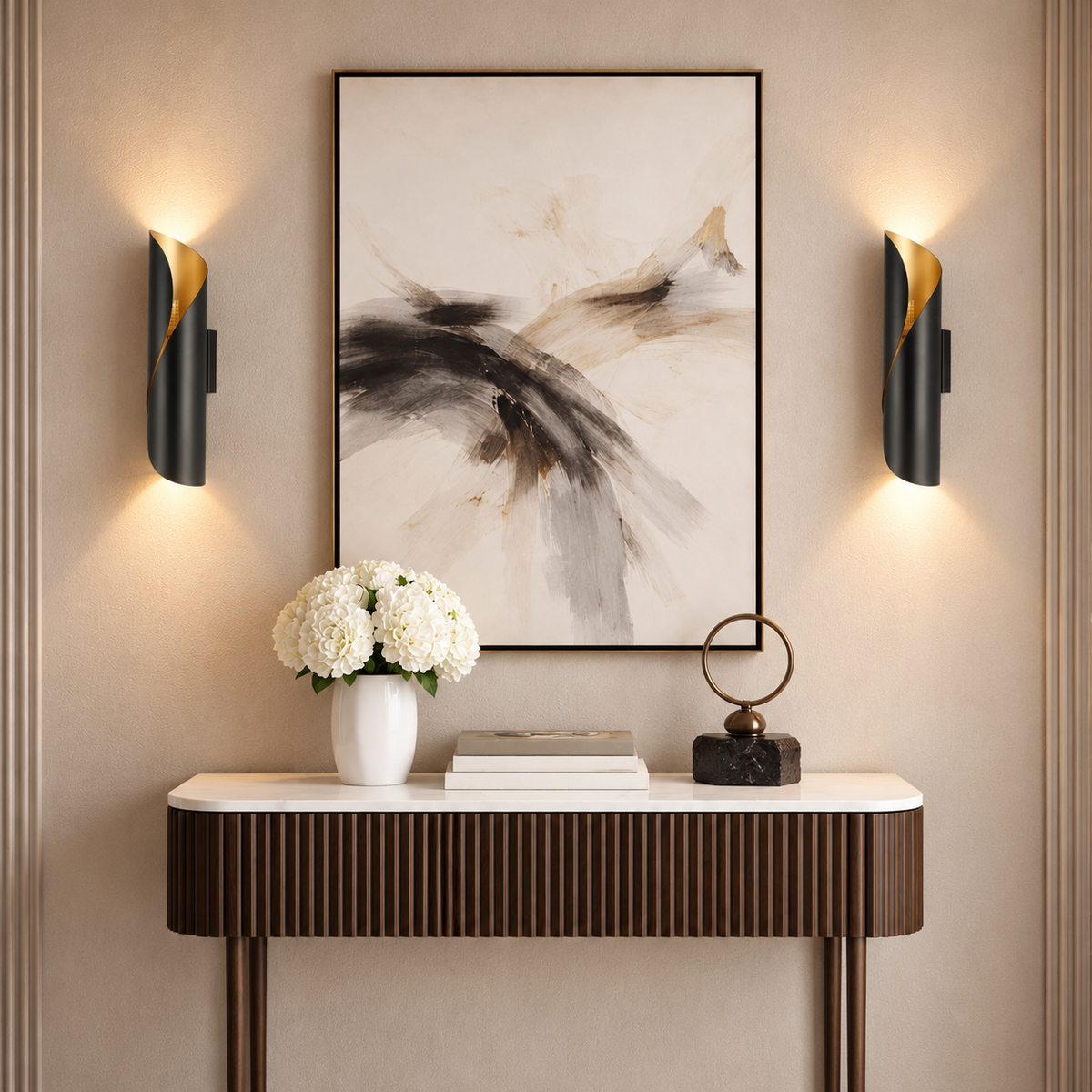 Pair of Cordoba black and gold wall lights framing abstract artwork above a fluted walnut console in an elegant hallway.
