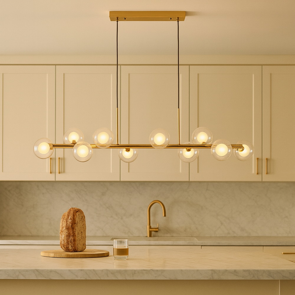Luxury kitchen with cream cabinets, gold handles, marble countertop, and a 115cm gold pendant bar light with glass globe shades hanging above the island.