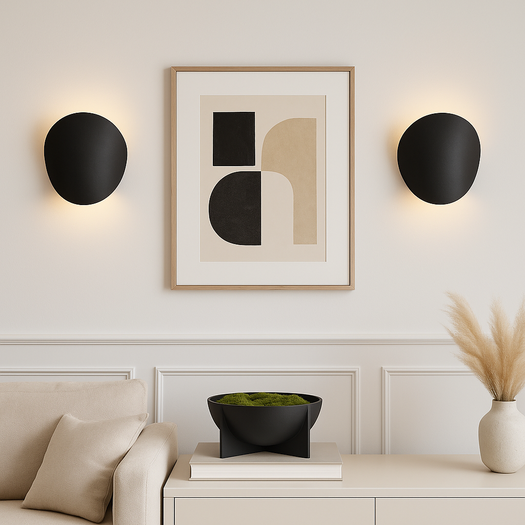 Pair of Delta black wall lights in a modern living room, framing abstract artwork above a sofa and console.