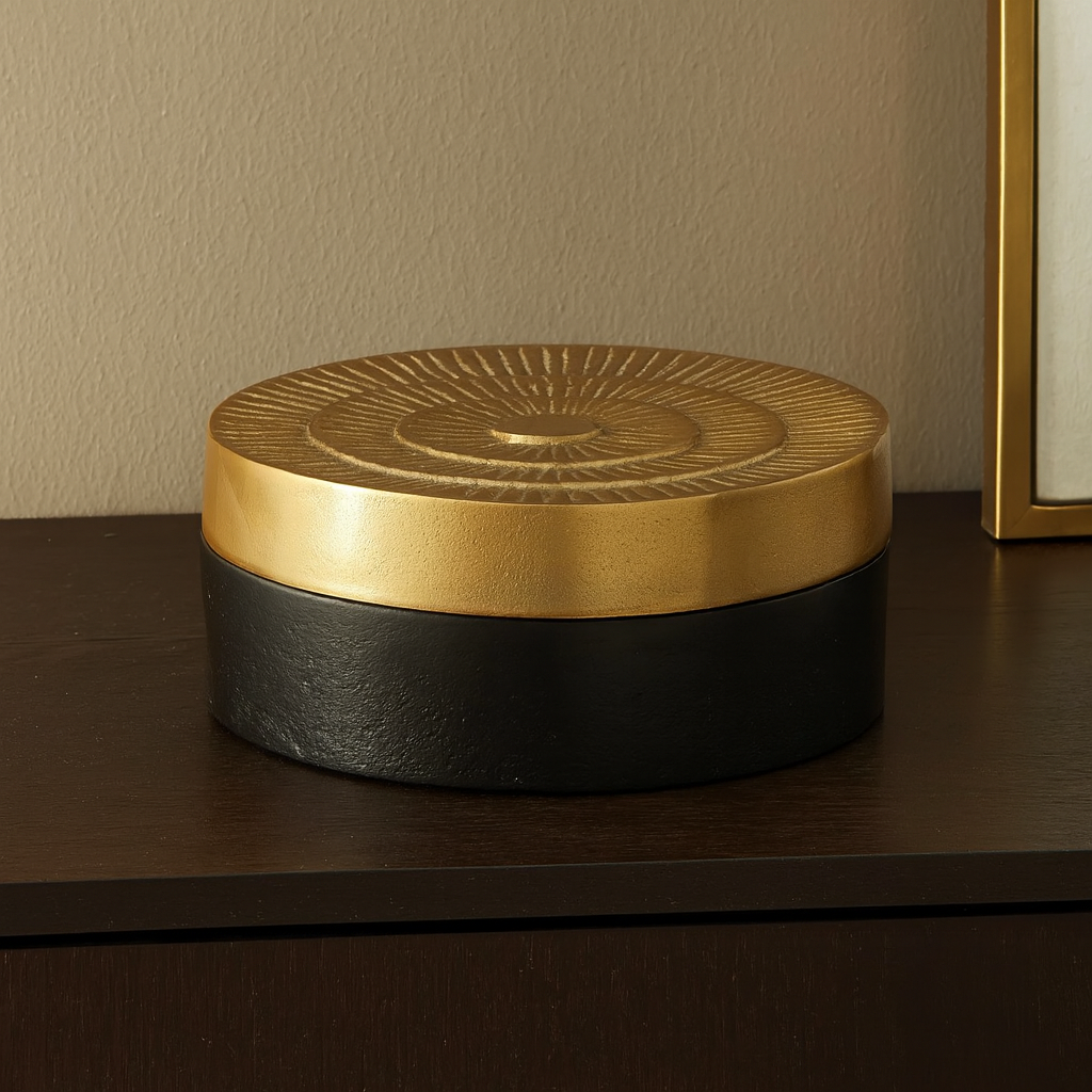 Black and gold Denali trinket box styled on a luxury sideboard in a modern living room