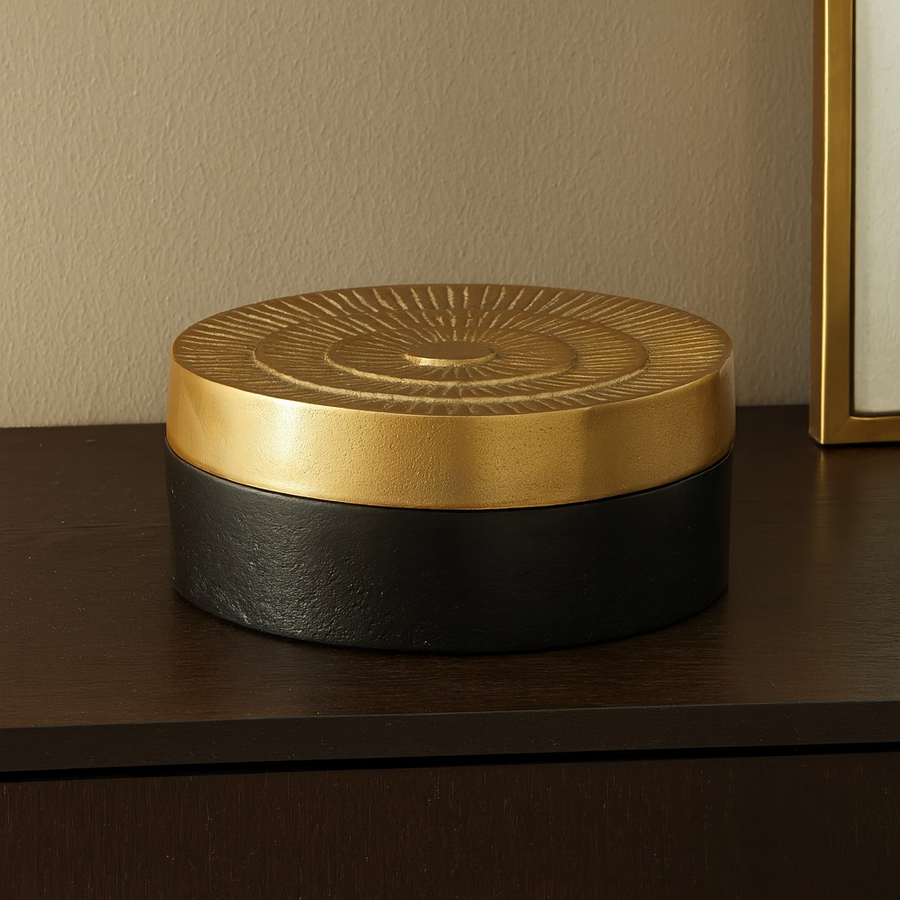 Black and gold Denali trinket box styled on a luxury sideboard in a modern living room