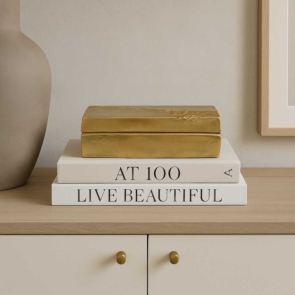 Gold storage box styled on coffee table books in Scandi living room